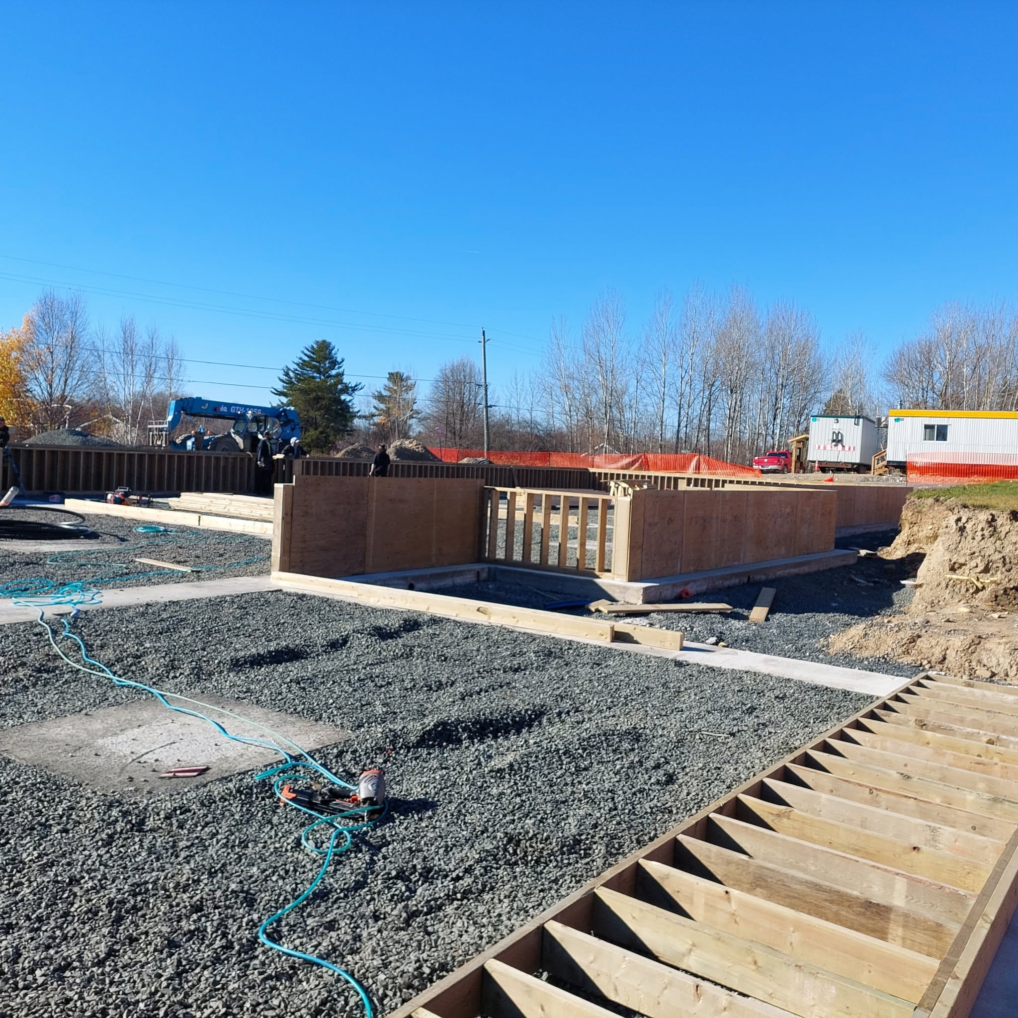 Foundation and site prep — crane on site, ICF forms