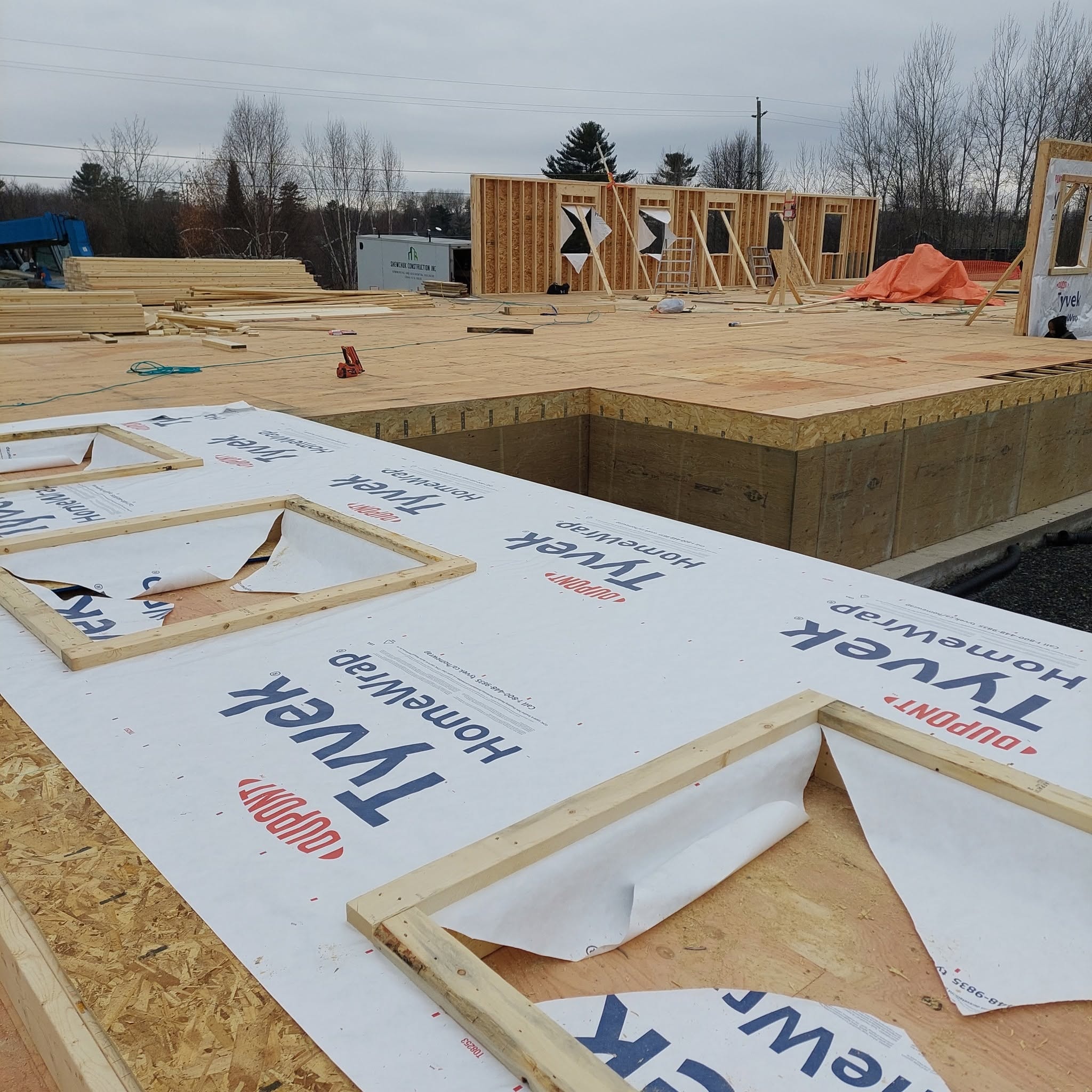 Roof trusses being set with orange clamp rigging